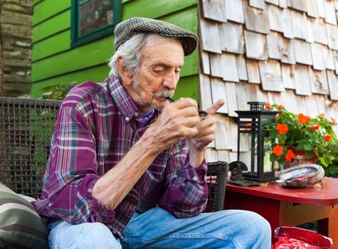 Lowell Davis lights up his corn cob pipe sitting outside his homeat Red Oak II farm Carrthage, Missouri the American filled farm he founded