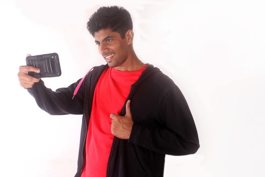 indian teenager taking selfies with his mobile phone