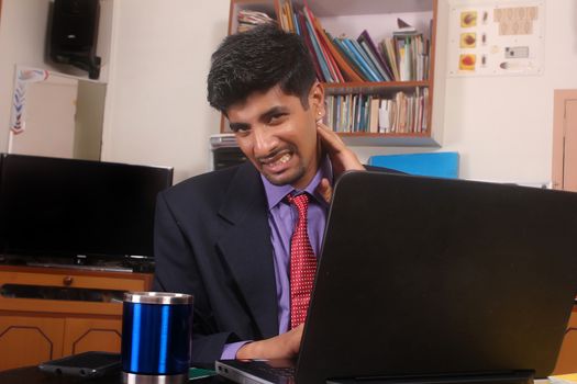 Businessman Using Computer Suffering From Neck Ache