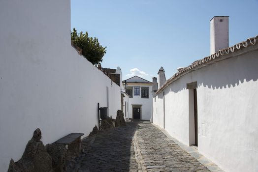 street with white houses monsaraz in alentejo portugal