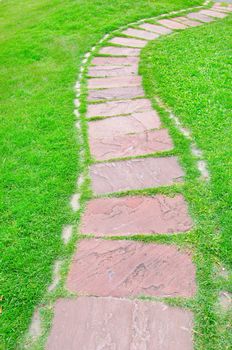 The Stone block walk path on grass.