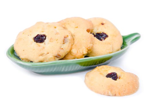 Oatmeal cookies with raisins on dish.