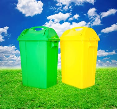 Green and yellow plastic trash recycling container ecology concept,with landscape background.