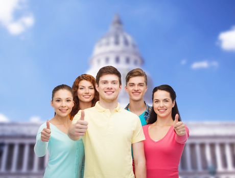 friendship, tourism, travel and people concept - group of smiling teenagers standing over white house background