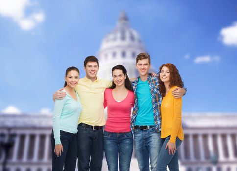 friendship, tourism, travel and people concept - group of smiling teenagers standing over white house background