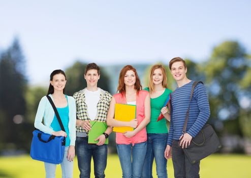 education and people concept - group of smiling students standing