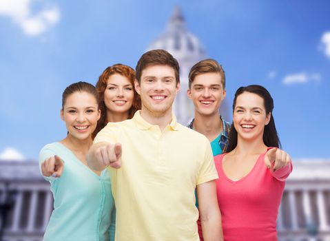 friendship, tourism, travel and people concept - group of smiling teenagers standing over white house background