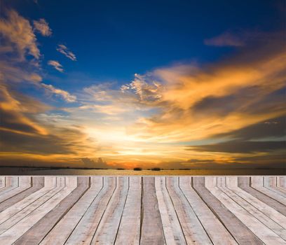 Wood plank as a pier or deck on blue sea water and sky background