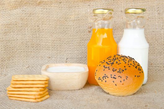 Whole wheat bread and biscuits in breakfast set on sack background