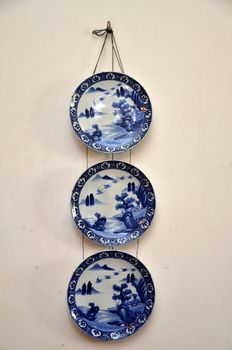 Three nice pottery plate hanging on the wall