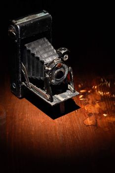 Closeup of old film camera on nice wooden background