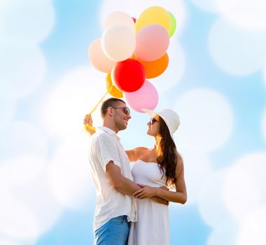 love, wedding, summer, dating and people concept - smiling couple wearing sunglasses with balloons hugging over blue lights background