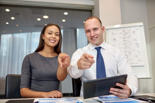 business, people, technology and teamwork concept - smiling businessman and businesswoman with tablet pc computer meeting in office