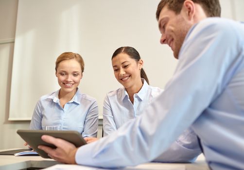 business, people, technology and teamwork concept - smiling businessman and businesswomen with tablet pc computer meeting in office