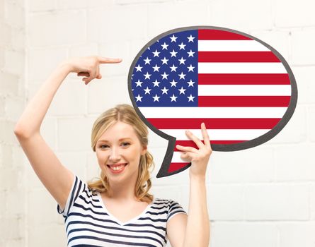 education, foreign language, english, people and communication concept - smiling woman holding text bubble of american flag