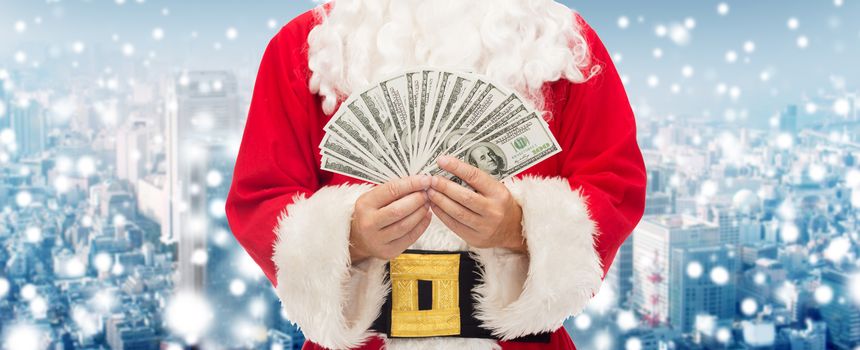 christmas, holidays, winning, currency and people concept - close up of santa claus with euro money over snowy city background