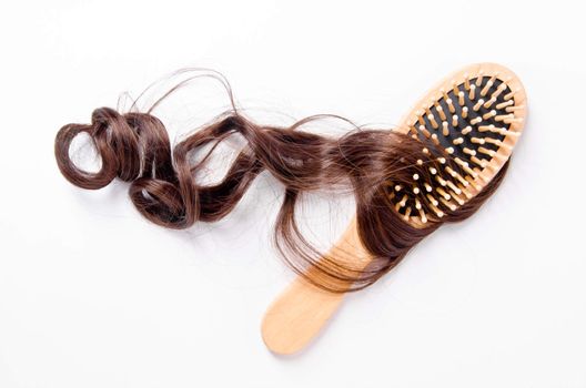 wooden comb brush with hair, on white background