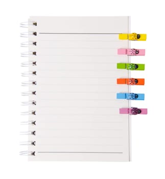 open diary ring binder and many color wood clamps isolated on white backgroun, clipping path
