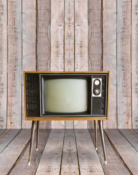 vintage television in old wooden room.