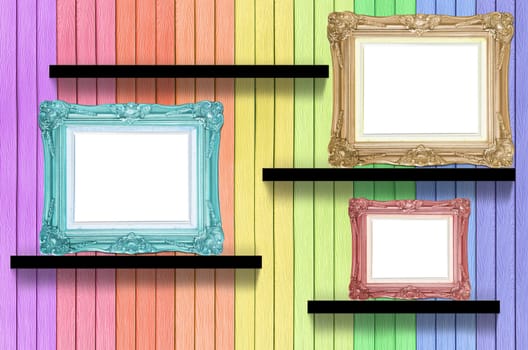 antique frame on colorful wood shelf on wood decorative wall