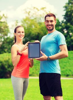 fitness, sport, friendship, technology and lifestyle concept - smiling couple with tablet pc computer outdoors