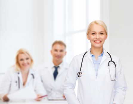 healthcare and medicine concept - smiling female doctor with stethoscope