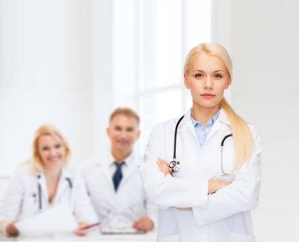 healthcare and medicine concept - serious female doctor with stethoscope