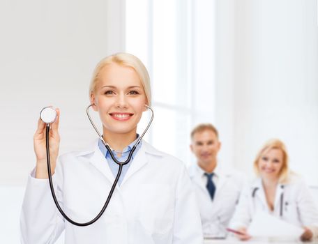 healthcare and medicine concept - smiling female doctor with stethoscope