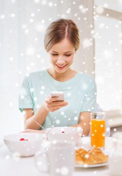 food, people and technology concept - smiling woman with smartphones and having breakfast at home