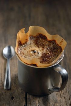 Ground coffee in cup and filter holder