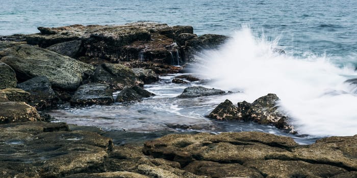 Rocks and waves at Point Cartwright beach in the afternoon. Sunshine Coast, Queensland.