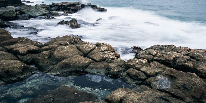 Rocks and waves at Point Cartwright beach in the afternoon. Sunshine Coast, Queensland.