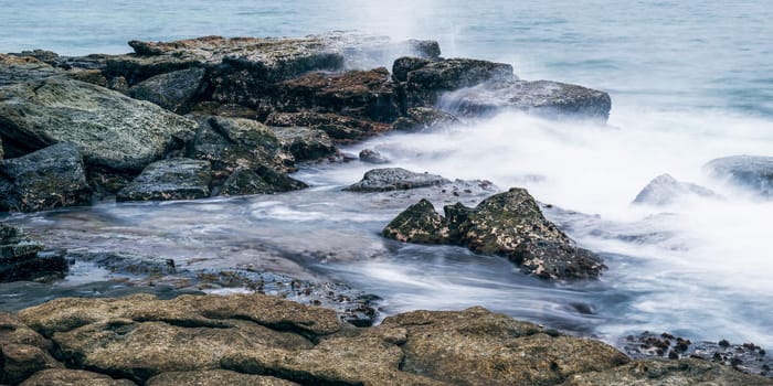 Rocks and waves at Point Cartwright beach in the afternoon. Sunshine Coast, Queensland.