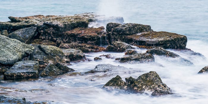 Rocks and waves at Point Cartwright beach in the afternoon. Sunshine Coast, Queensland.