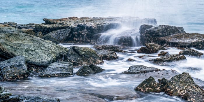 Rocks and waves at Point Cartwright beach in the afternoon. Sunshine Coast, Queensland.