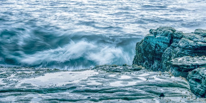 Rocks and waves at Point Cartwright beach in the afternoon. Sunshine Coast, Queensland.