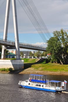 The boat "Admiral" on the Tura River in Tyumen, under the foot bridge. Russia.