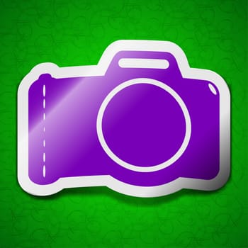 Photo camera icon sign. Symbol chic colored sticky label on green background. illustration