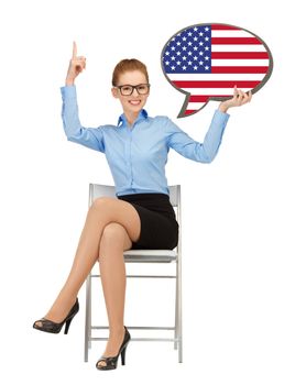 education, foreign language, english, people and communication concept - smiling woman holding text bubble of american flag and pointing finger up