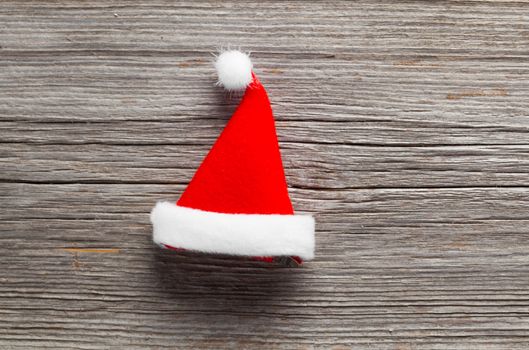 Single Santa Claus red hat on wooden background