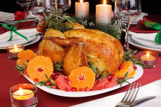Baked chicken with mandarin, grapefruit, pomegranate at the Christmas table