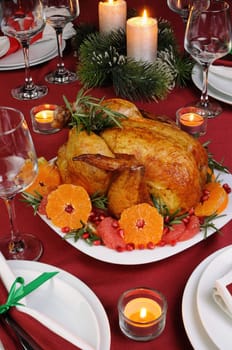 Baked chicken with mandarin, grapefruit, pomegranate at the Christmas table