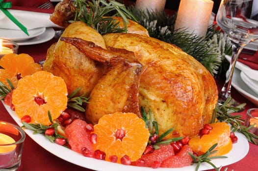 Baked chicken with mandarin, grapefruit, pomegranate at the Christmas table
