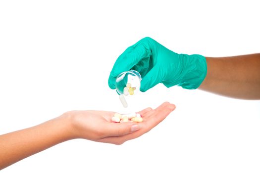 doctor hands giving capsule and pill, on white background