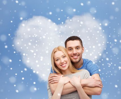love, people and family concept - smiling couple hugging over blue sky, snow and heart shape cloud background