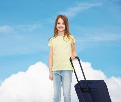 travel, holiday, vacation, childhood and transportation concept - smiling little girl with suitcase