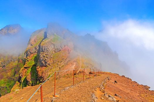Hiking trail from Pico do Arieiro to Pico Ruivo, Madeira, Portugal - Colorful volcanic mountain landscape with clouds