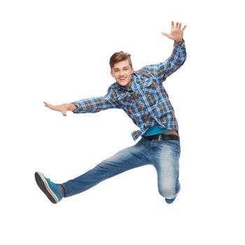 happiness, freedom, movement and people concept - smiling young man jumping in air