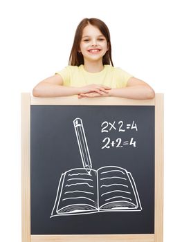 people, childhood, doodle and education concept - happy little girl with blackboard