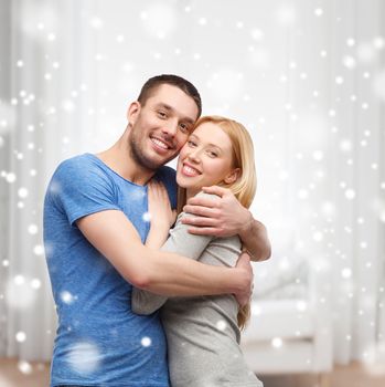 love, people and family concept - smiling couple hugging at home